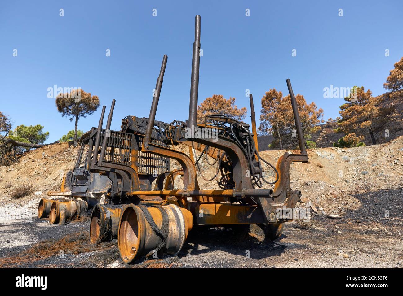 Heavy machinery burned by fire in the Jubrique fire next to Sierra Bermaja in the Genal Valley, Malaga. Andalusia, Spain. September 2021 Stock Photo