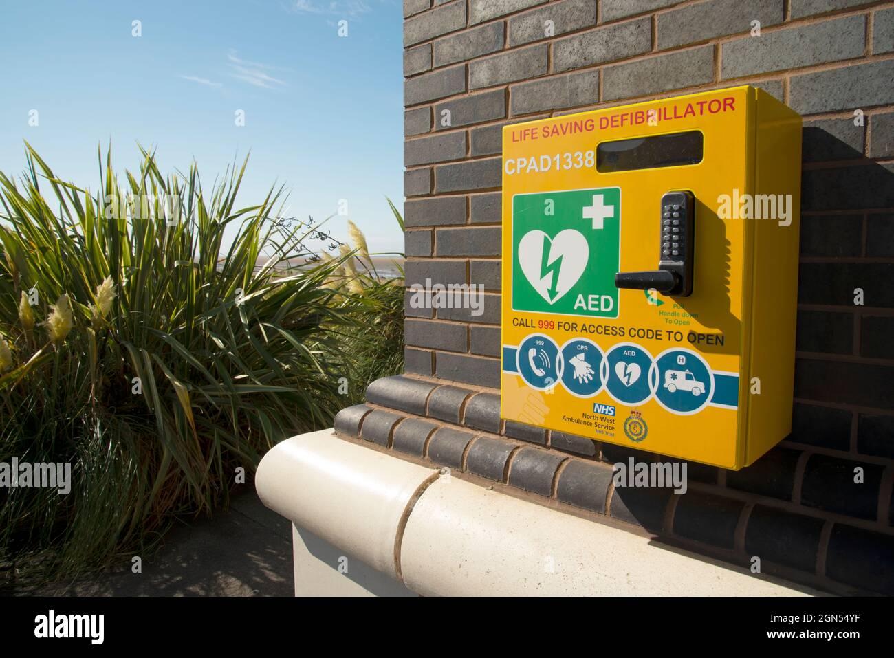 A cardiac defibrillator situated on the exterior wall of Hoylake Lifeboat Station on the Wirral. Stock Photo