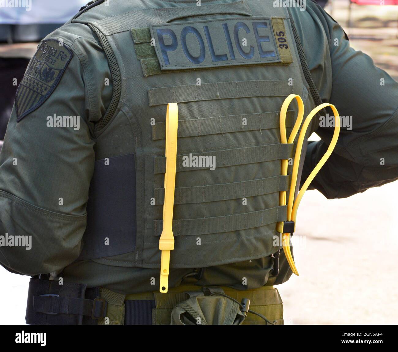 Yellow zip ties or plastic handcuffs on the back of a police officer's vest in Santa Fe, New Mexico. Stock Photo