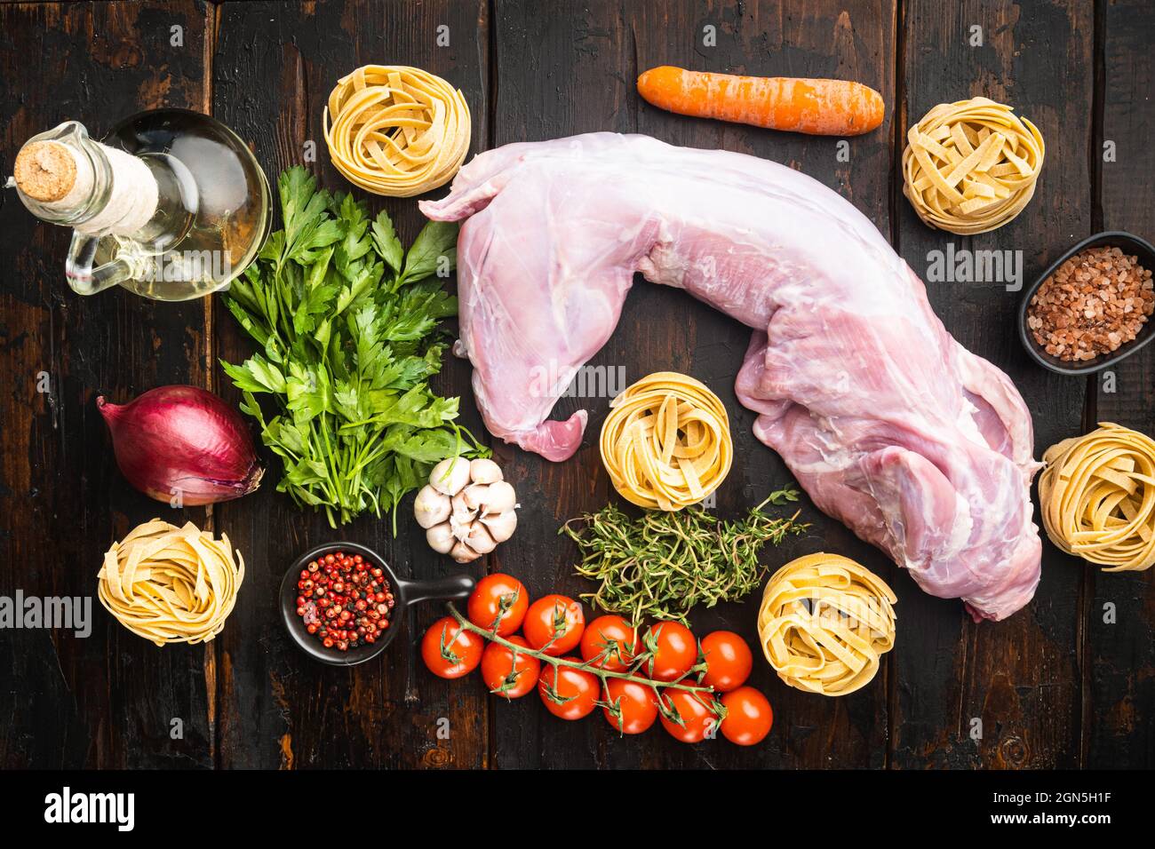 Raw Rabbit Cut Raw fresh whole rabbit cut for stewing set, on old dark wooden table ...