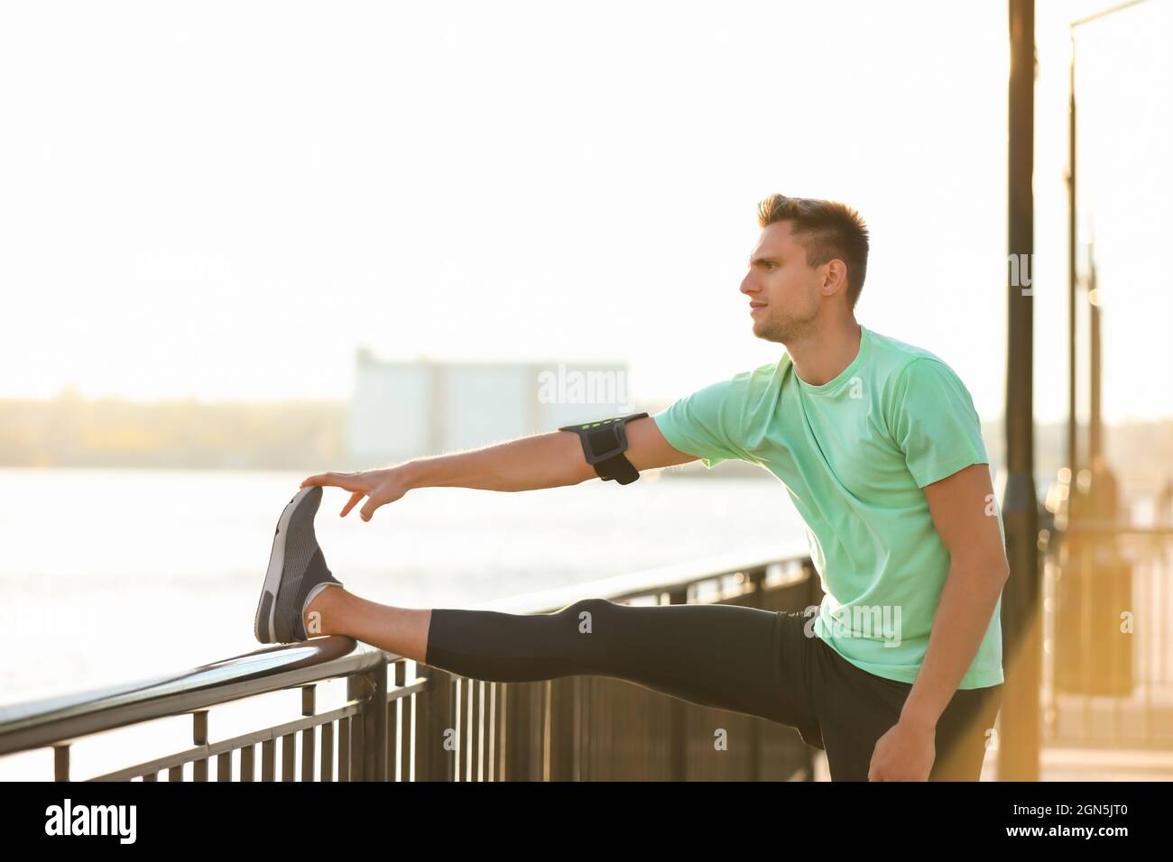 Man stretching on fence hi-res stock photography and images - Alamy