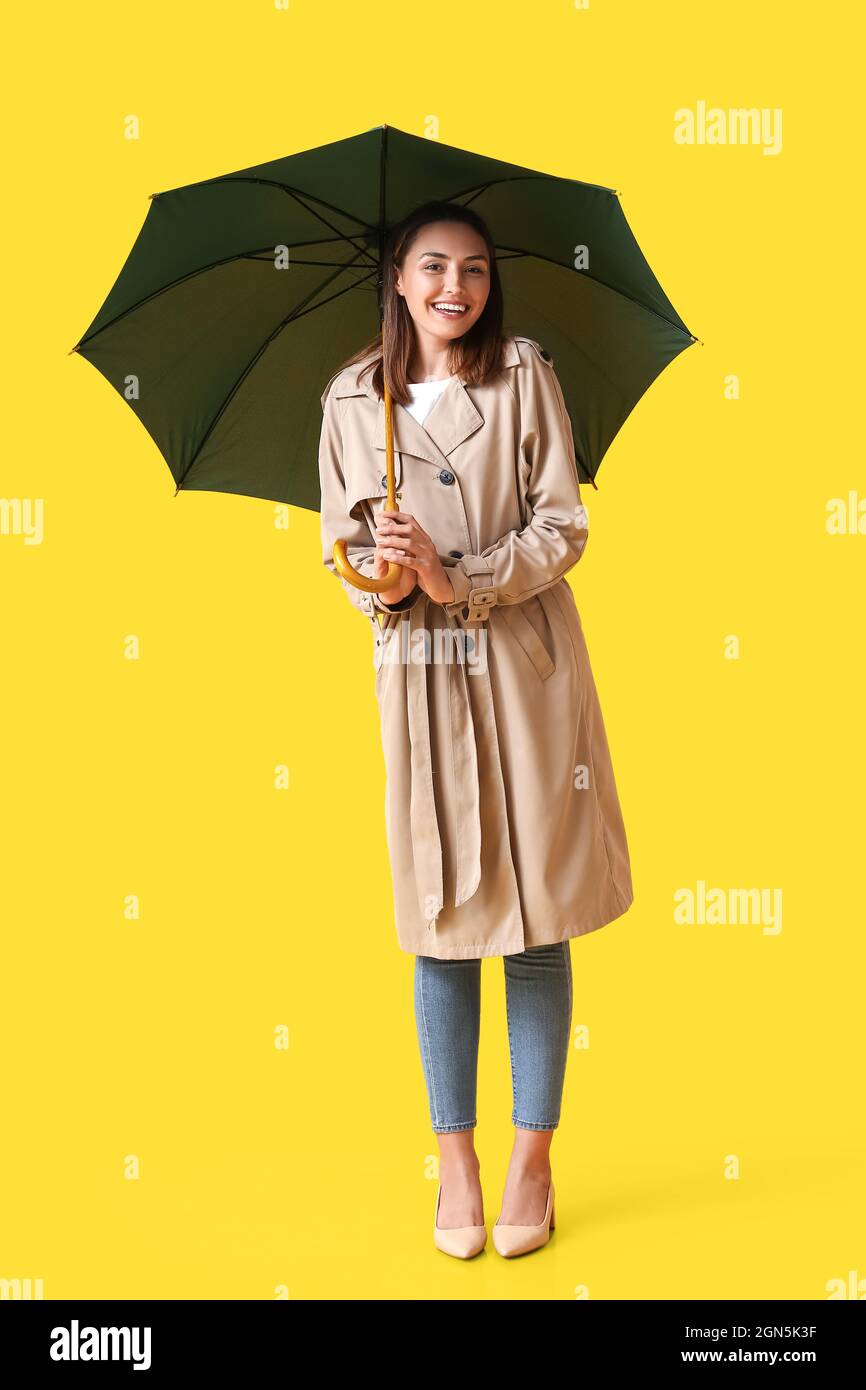 Beautiful young woman with umbrella on color background Stock Photo - Alamy