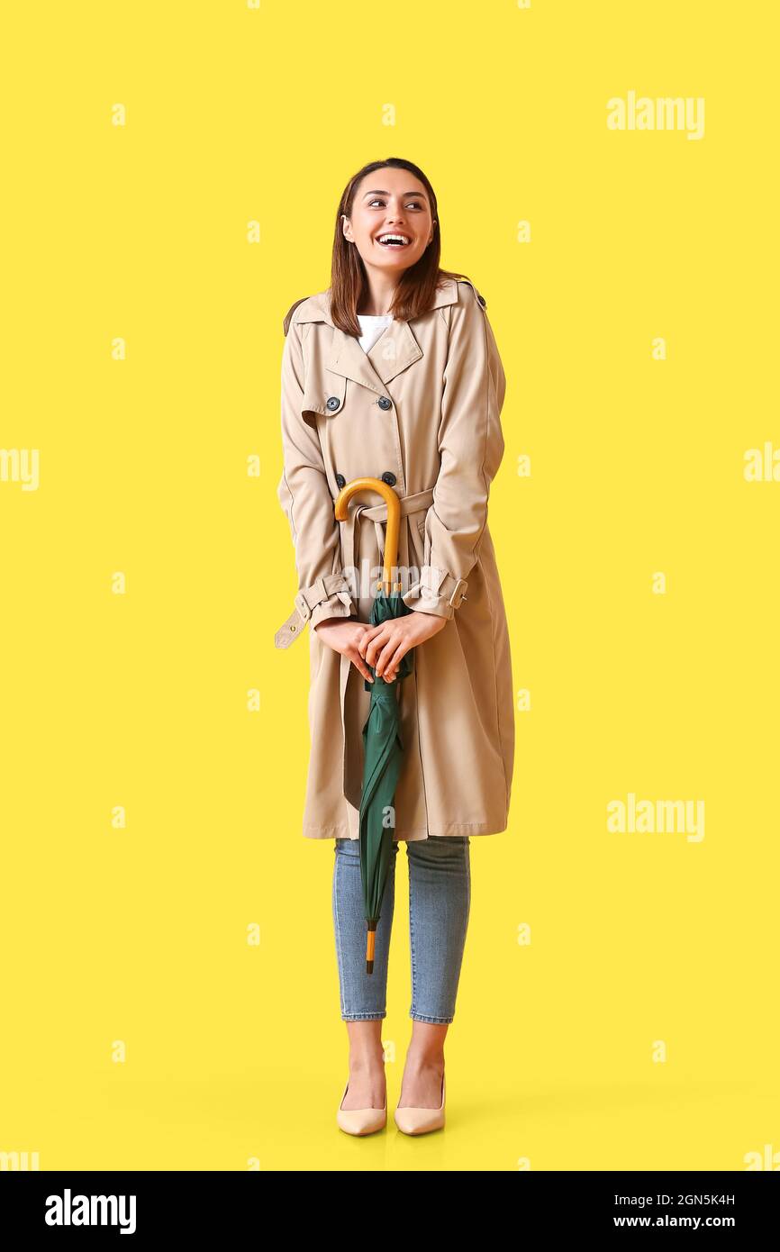 Beautiful young woman with umbrella on color background Stock Photo - Alamy