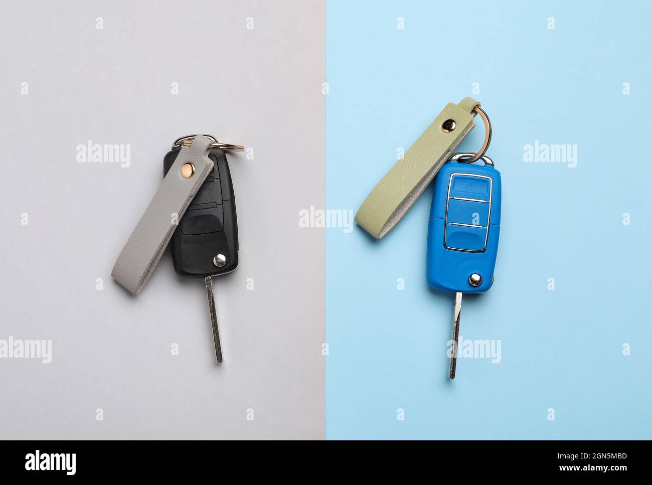 Car keys with leather keychains on color background Stock Photo