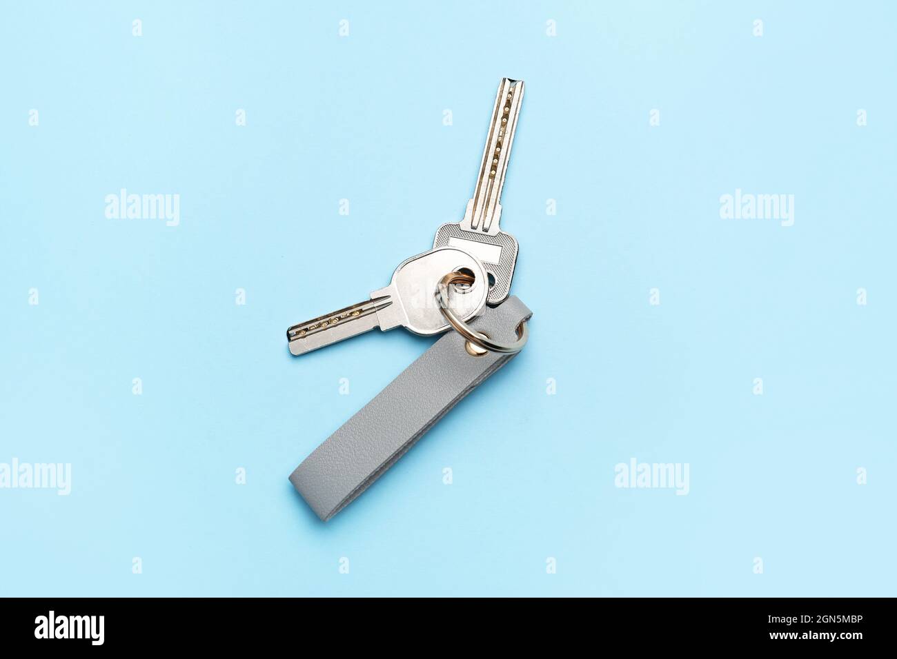 Keys with leather keychain on color background Stock Photo