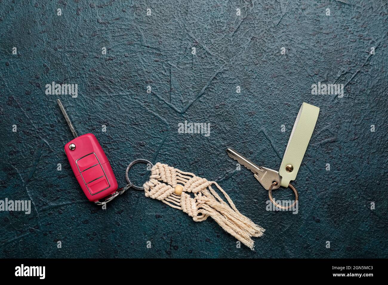 Keys with keychains on dark background Stock Photo