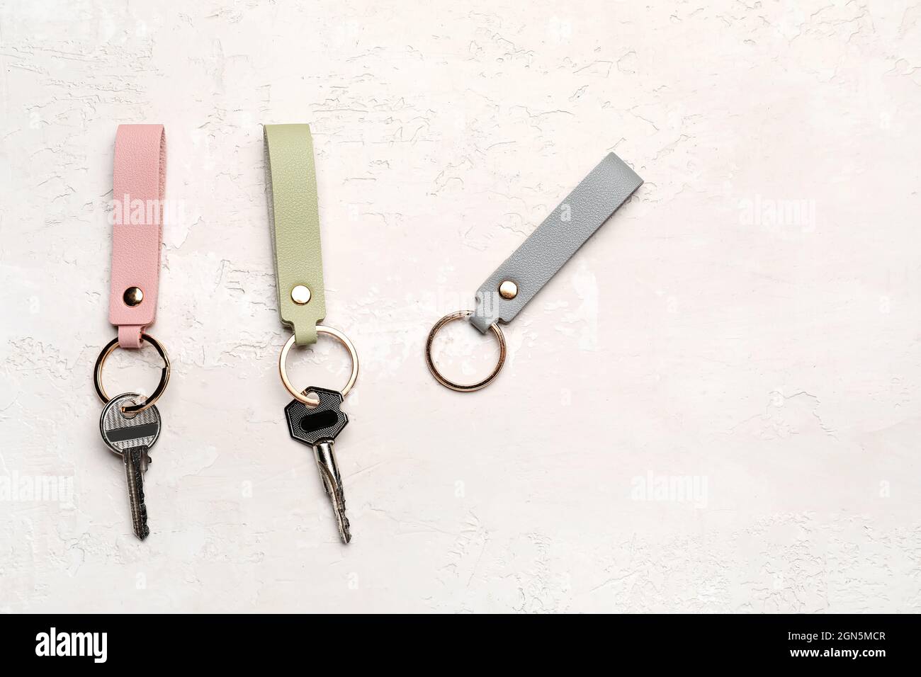 Keys with leather keychains on light background Stock Photo