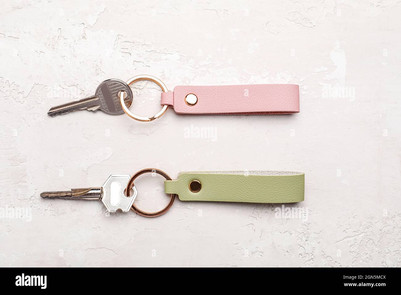 Keys with leather keychains on light background Stock Photo