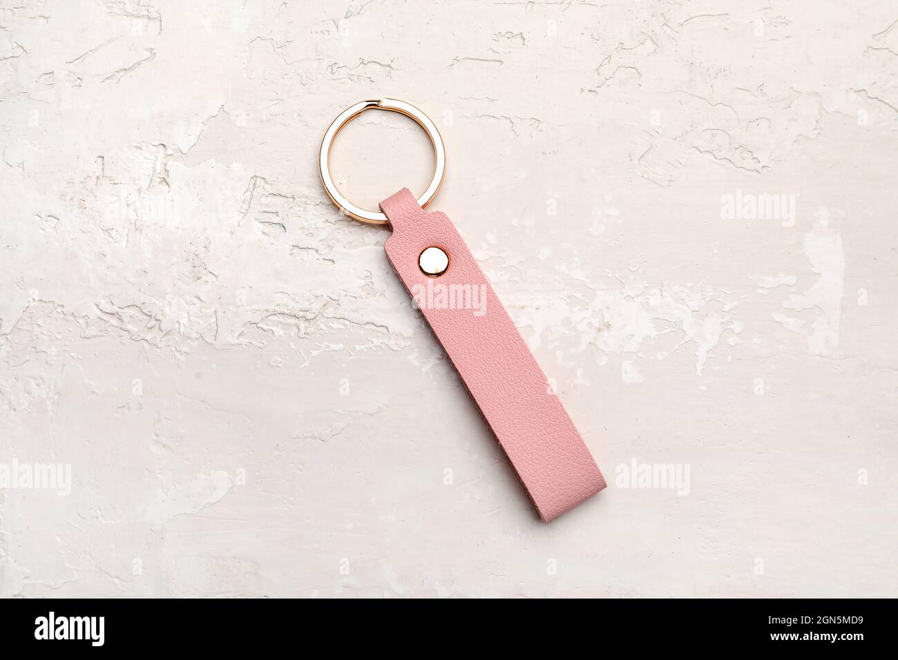 Leather keychain on light background Stock Photo