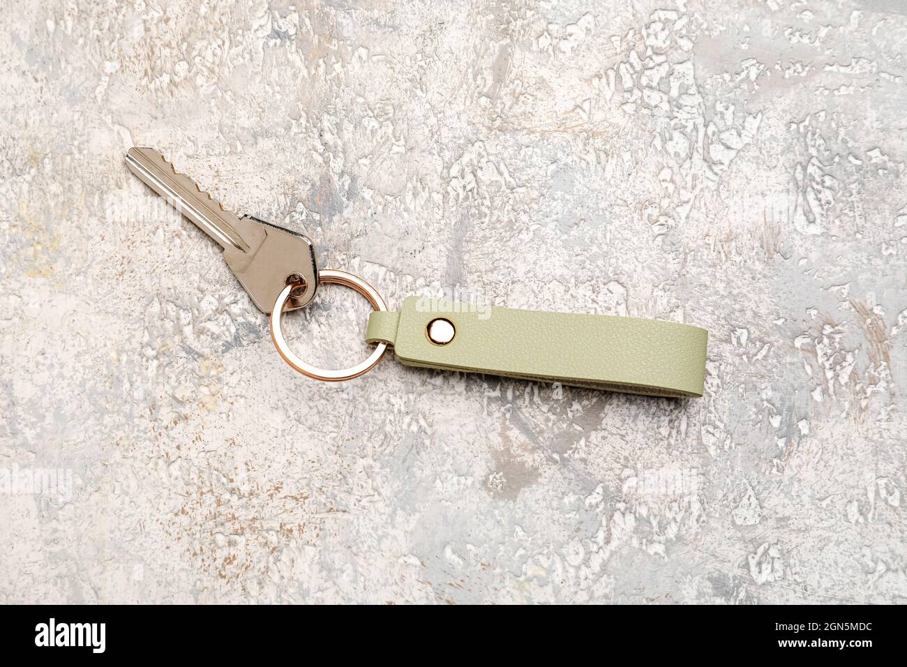 Key with leather keychain on light background Stock Photo