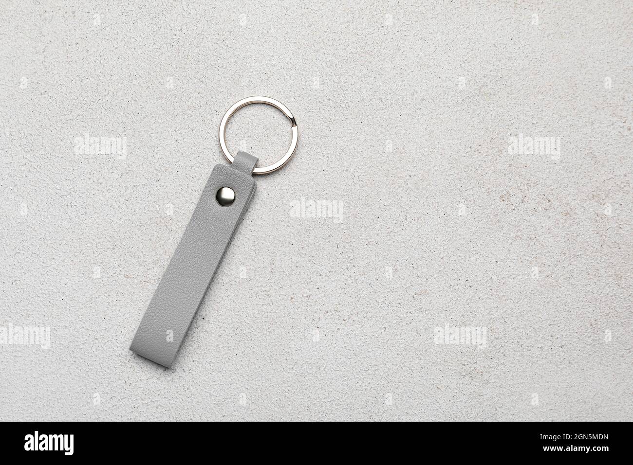 Leather keychain on light background Stock Photo