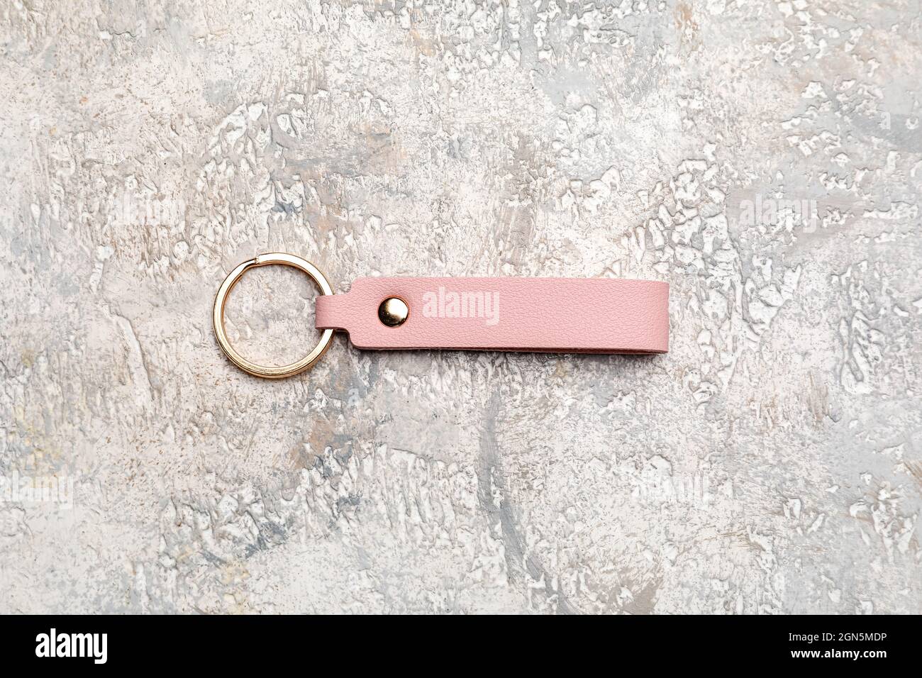 Leather keychain on light background Stock Photo