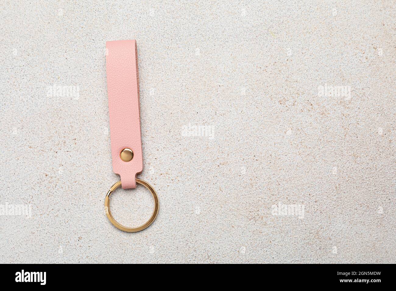Leather keychain on light background Stock Photo