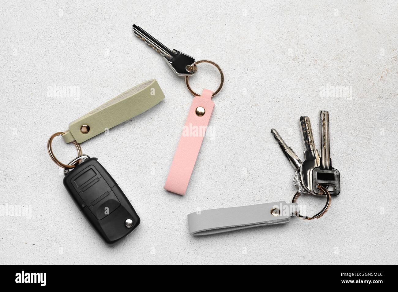 Keys with leather keychains on light background Stock Photo