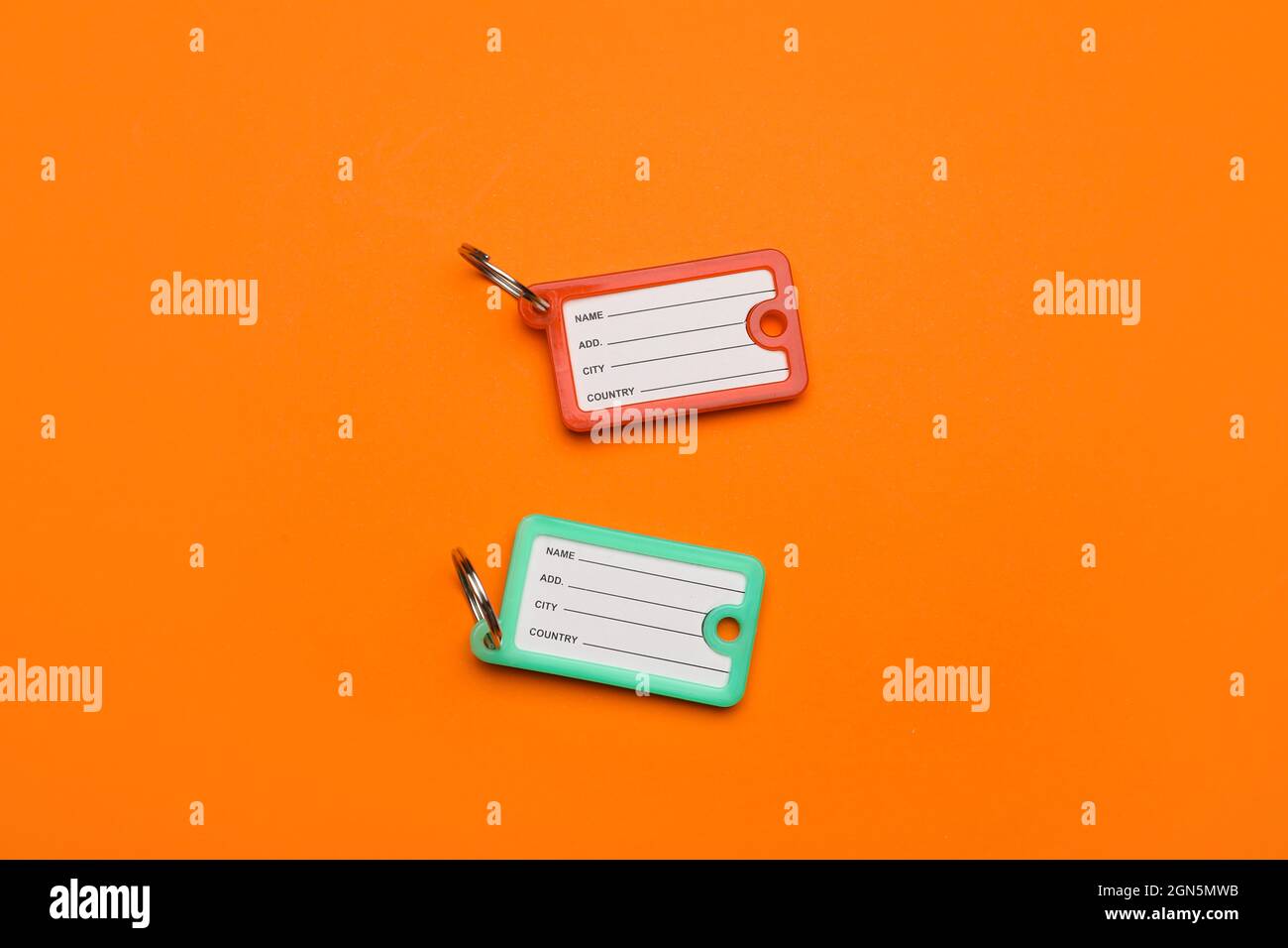 New plastic key tags on orange background Stock Photo Alamy