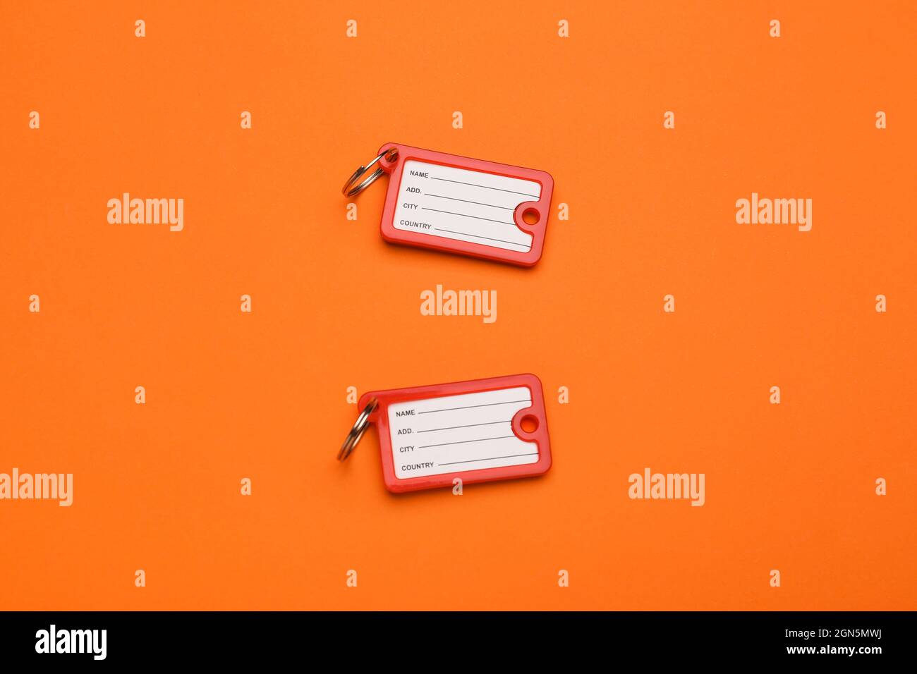 New plastic key tags on orange background Stock Photo - Alamy