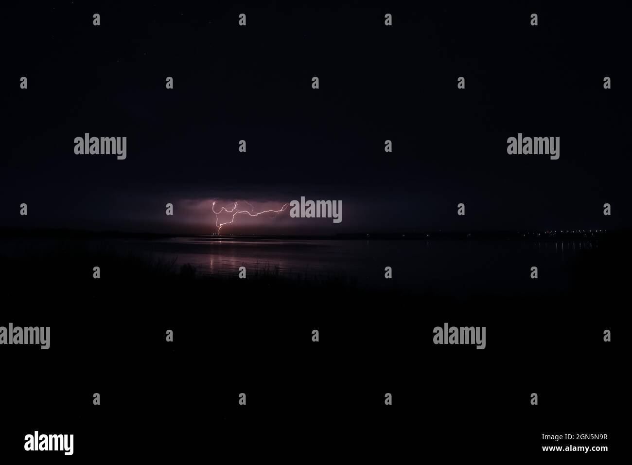 Dark sky with lightning over night city Stock Photo - Alamy
