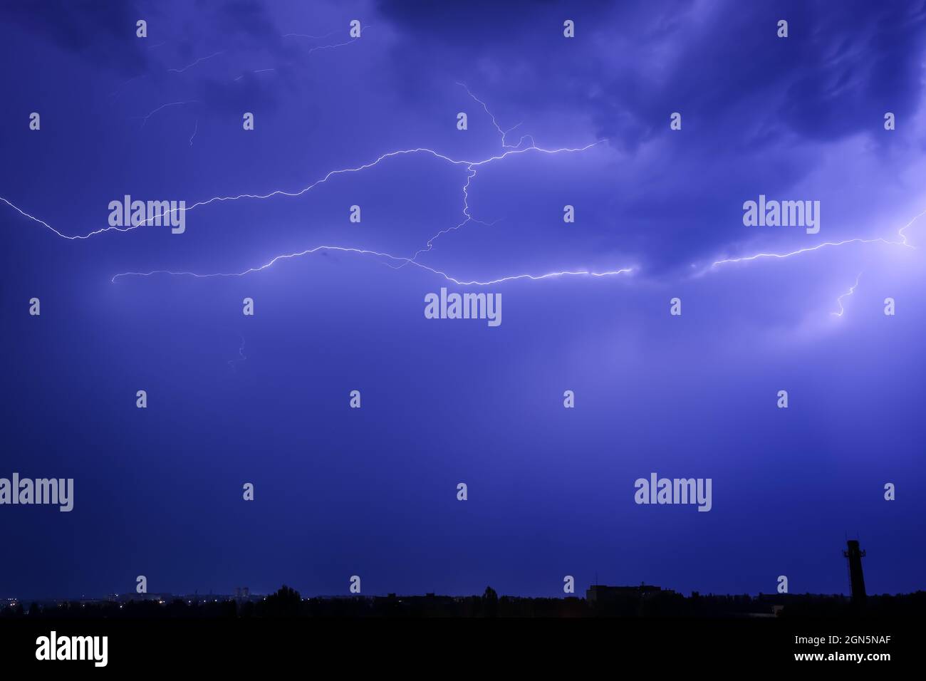 Dark sky with lightning over night city Stock Photo - Alamy