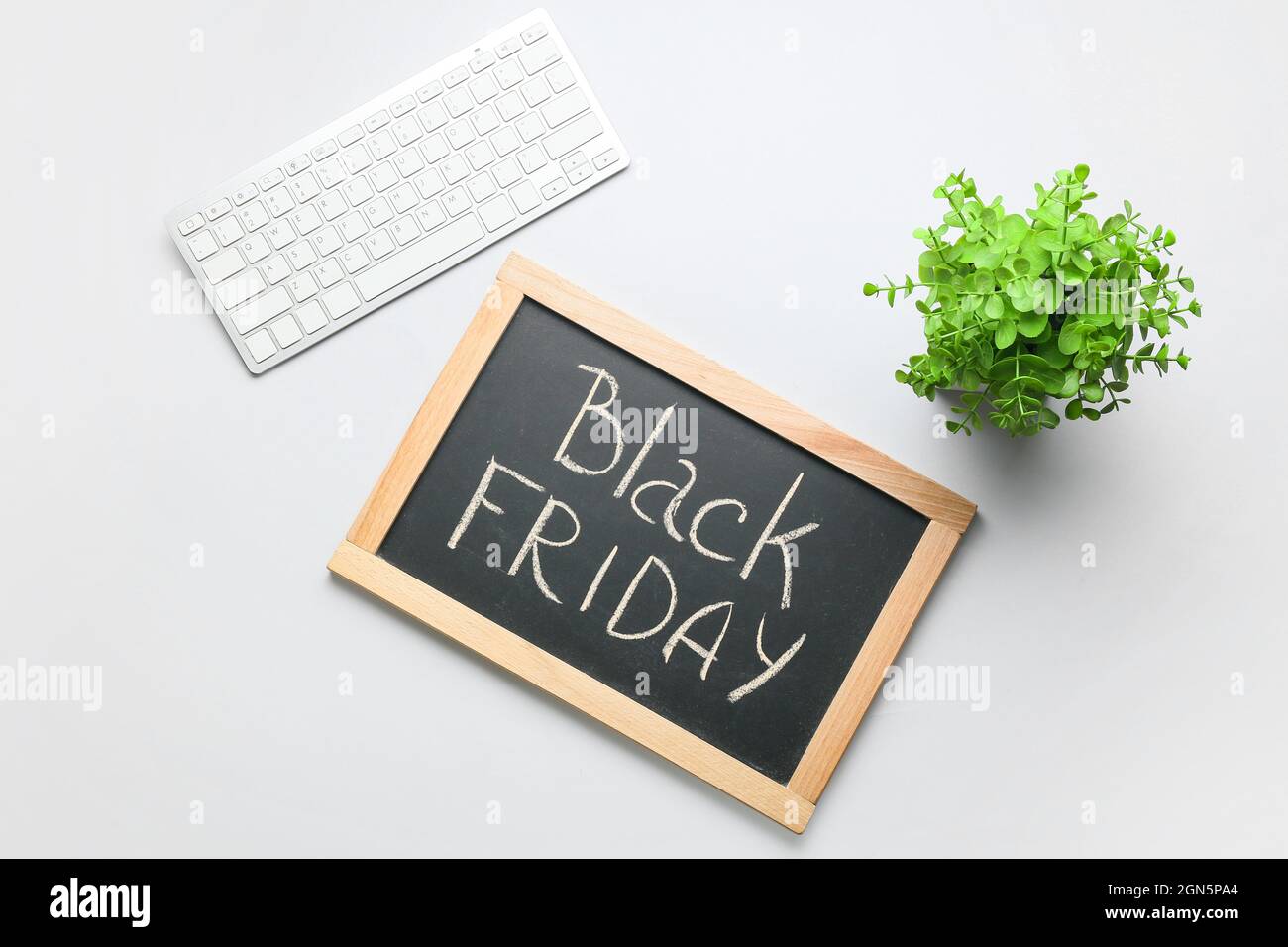 Chalkboard with text BLACK FRIDAY and PC keyboard on light background Stock Photo