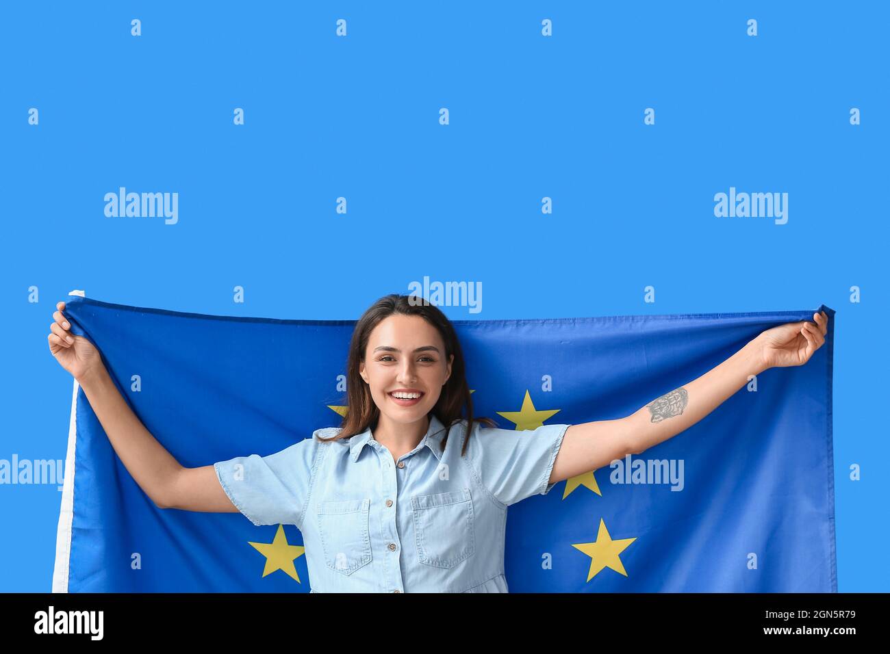 Young woman with flag of European Union on color background Stock Photo ...
