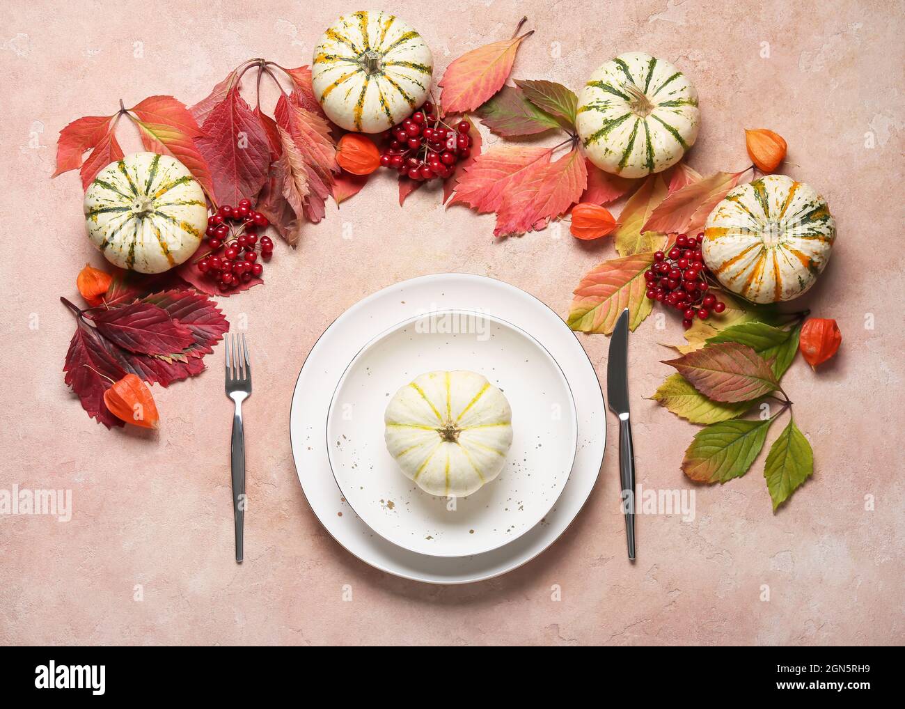 Stylish table setting and autumn decor on color background Stock Photo