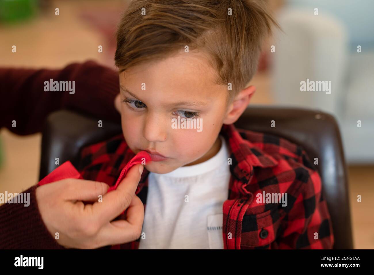 Hand of father cleaning son mouth after christmas meal Stock Photo