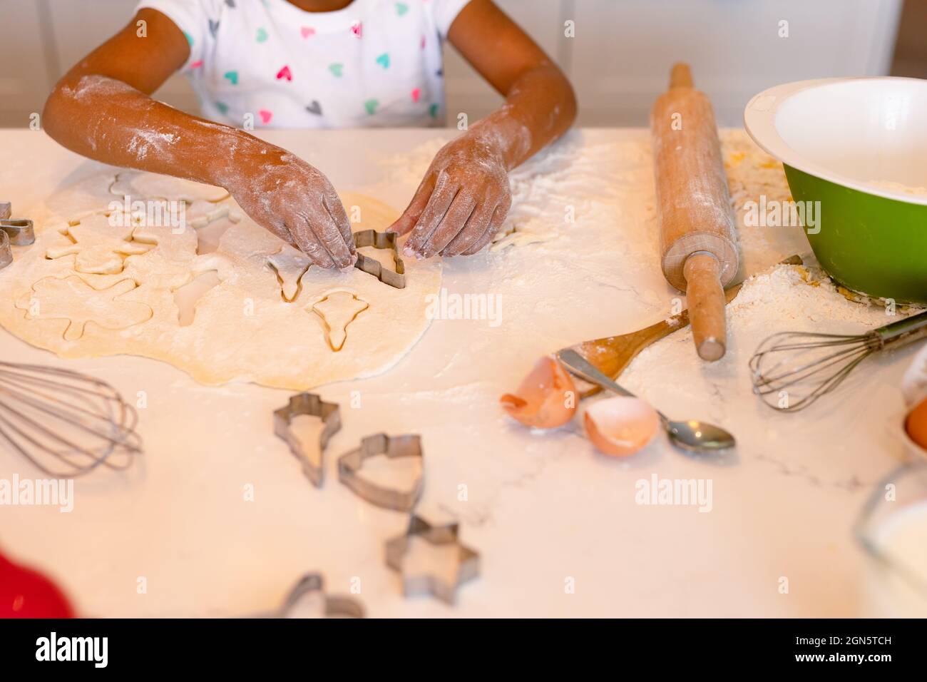 Hands of african american messy girl baking in kitchen Stock Photo
