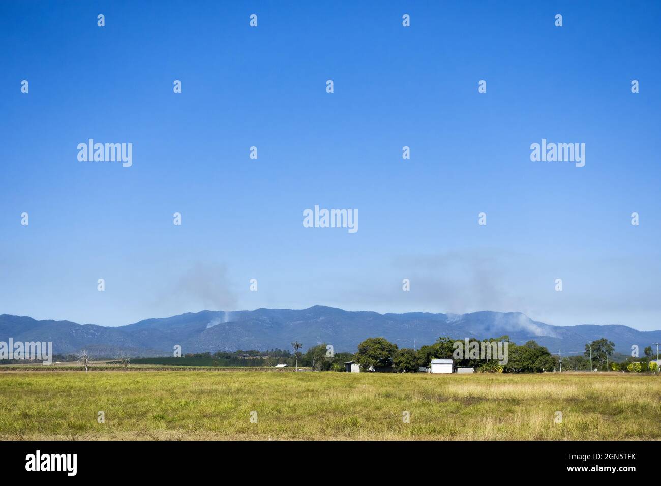 Smoke in the forest covered hills Stock Photo - Alamy