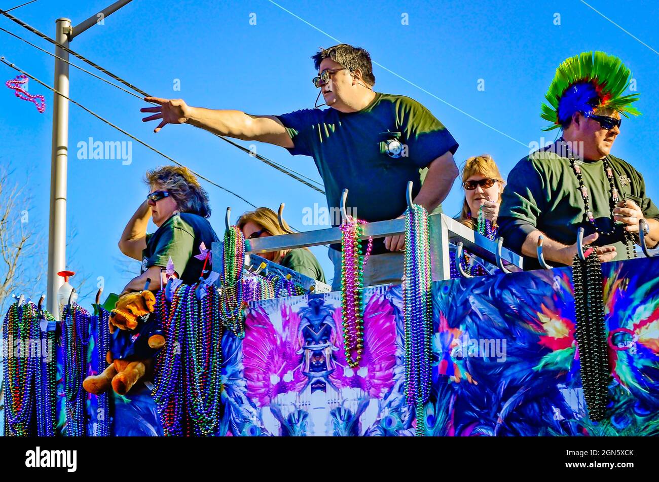 A man throws Mardi Gras beads from a Mardi Gras float during the Joe Cain  Day Mardi Gras parade, Feb. 7, 2016, in Mobile, Alabama Stock Photo - Alamy