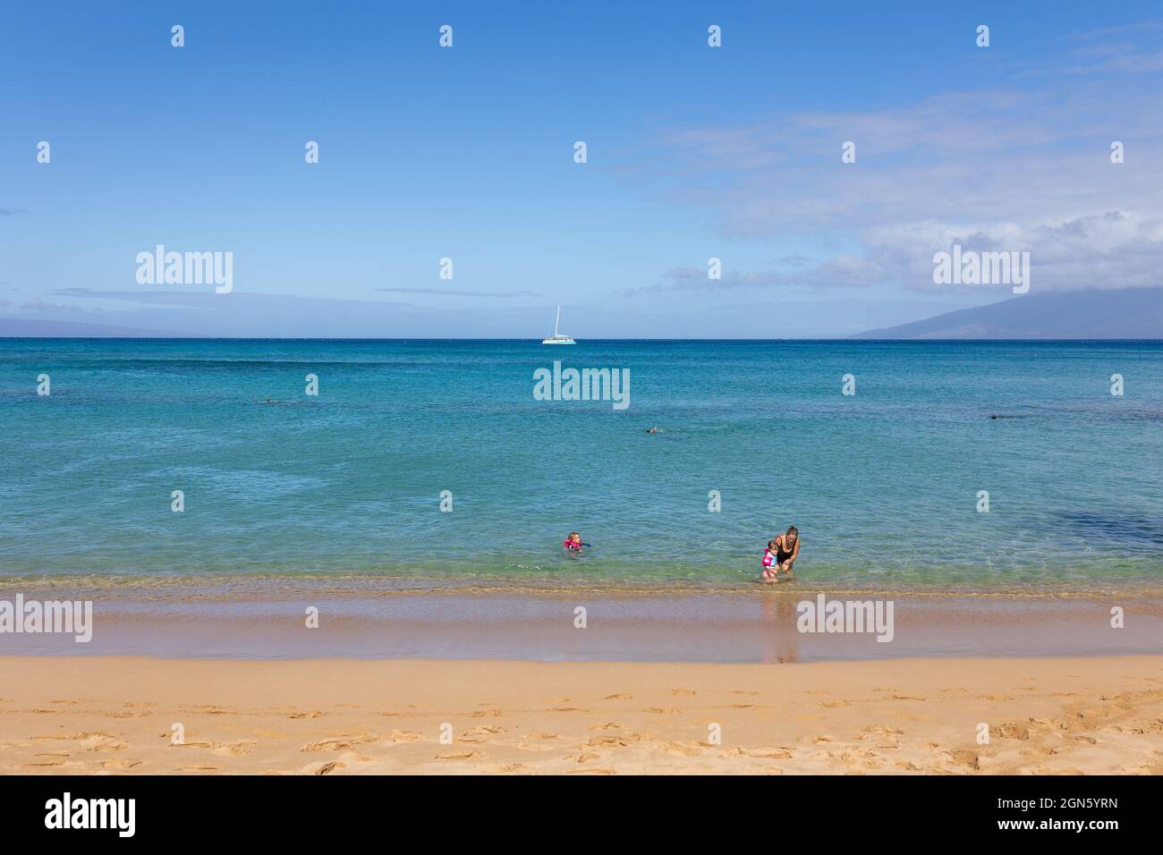 Tourist enjoying tropical beach with white sand and crystal clear water