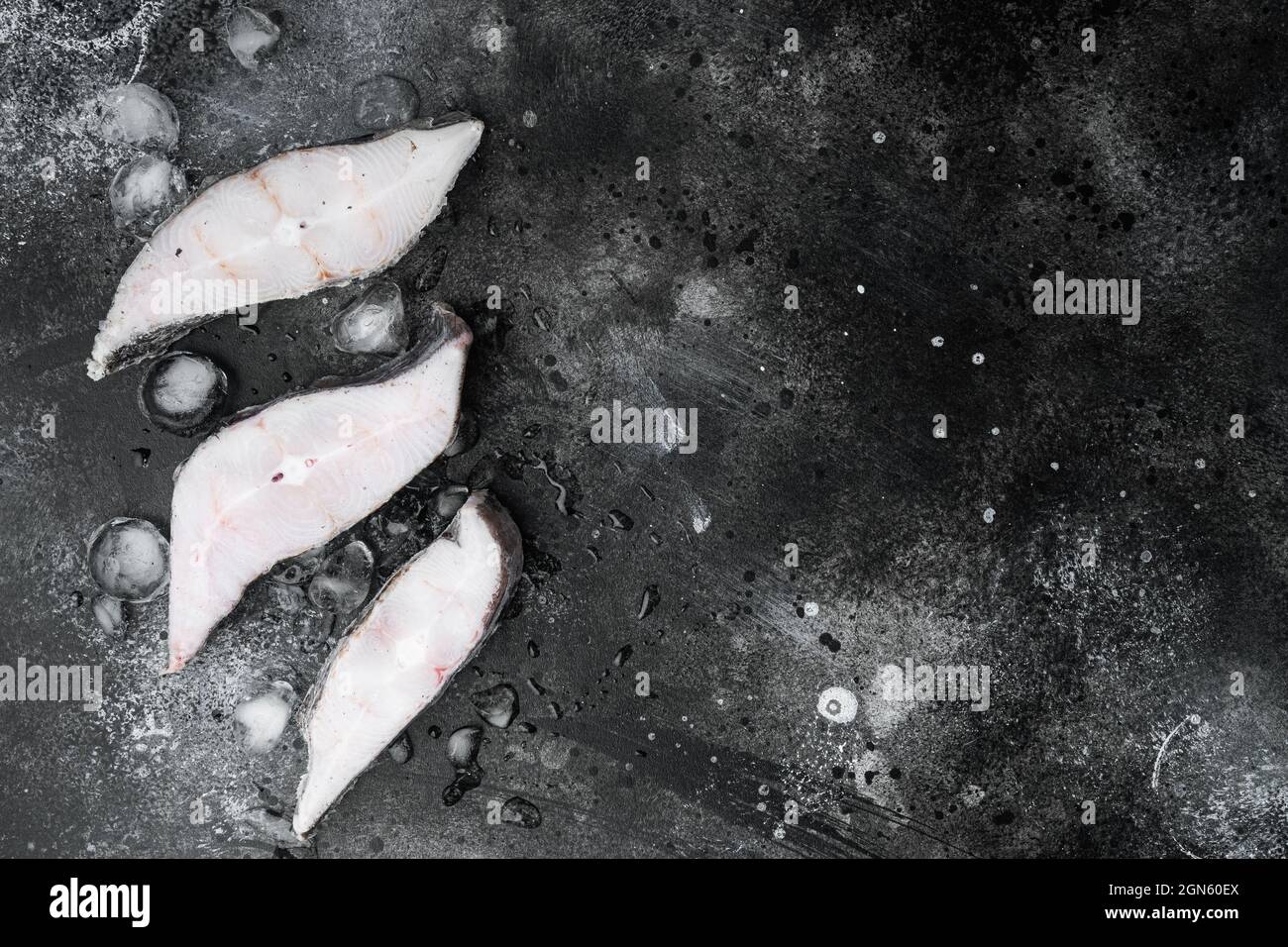 Frozen fish cut set, on black dark stone table background, top view ...