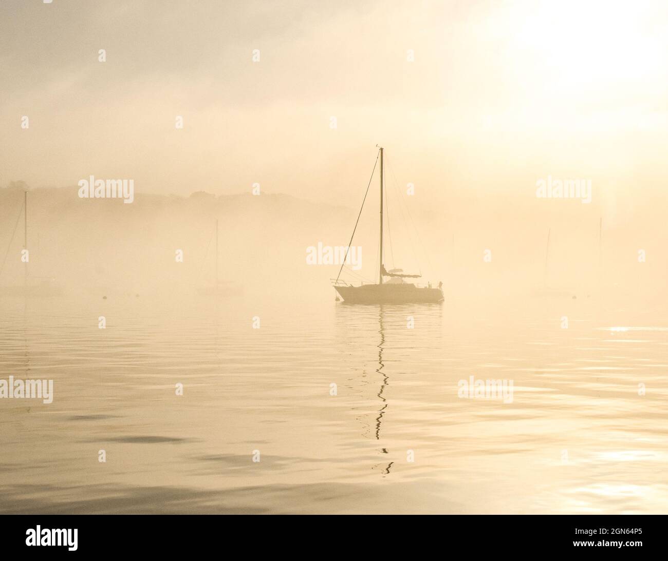 Sailboat in the fog. Port Jefferson Harbor, New York, USA.. Copy space. Stock Photo