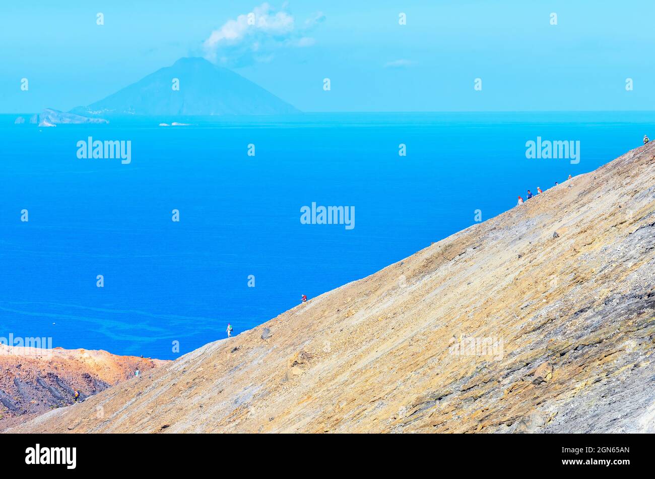 Hikers walking on Gran Crater rim, Vulcano Island, Aeolian Islands, Sicily, Italy Stock Photo