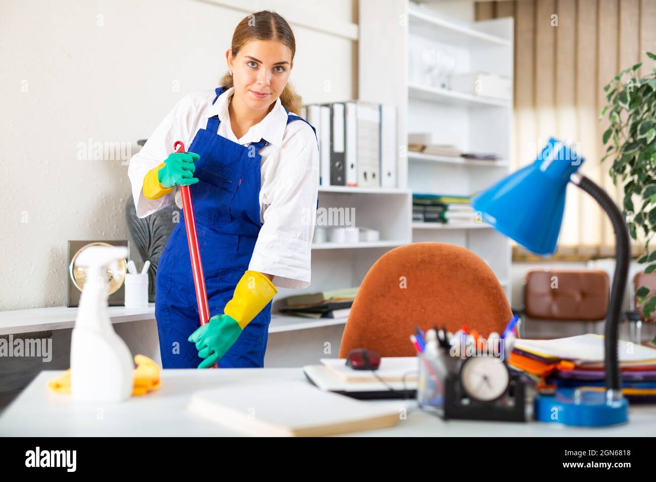 Young woman from a cleaning company conducts a wet cleaning of the