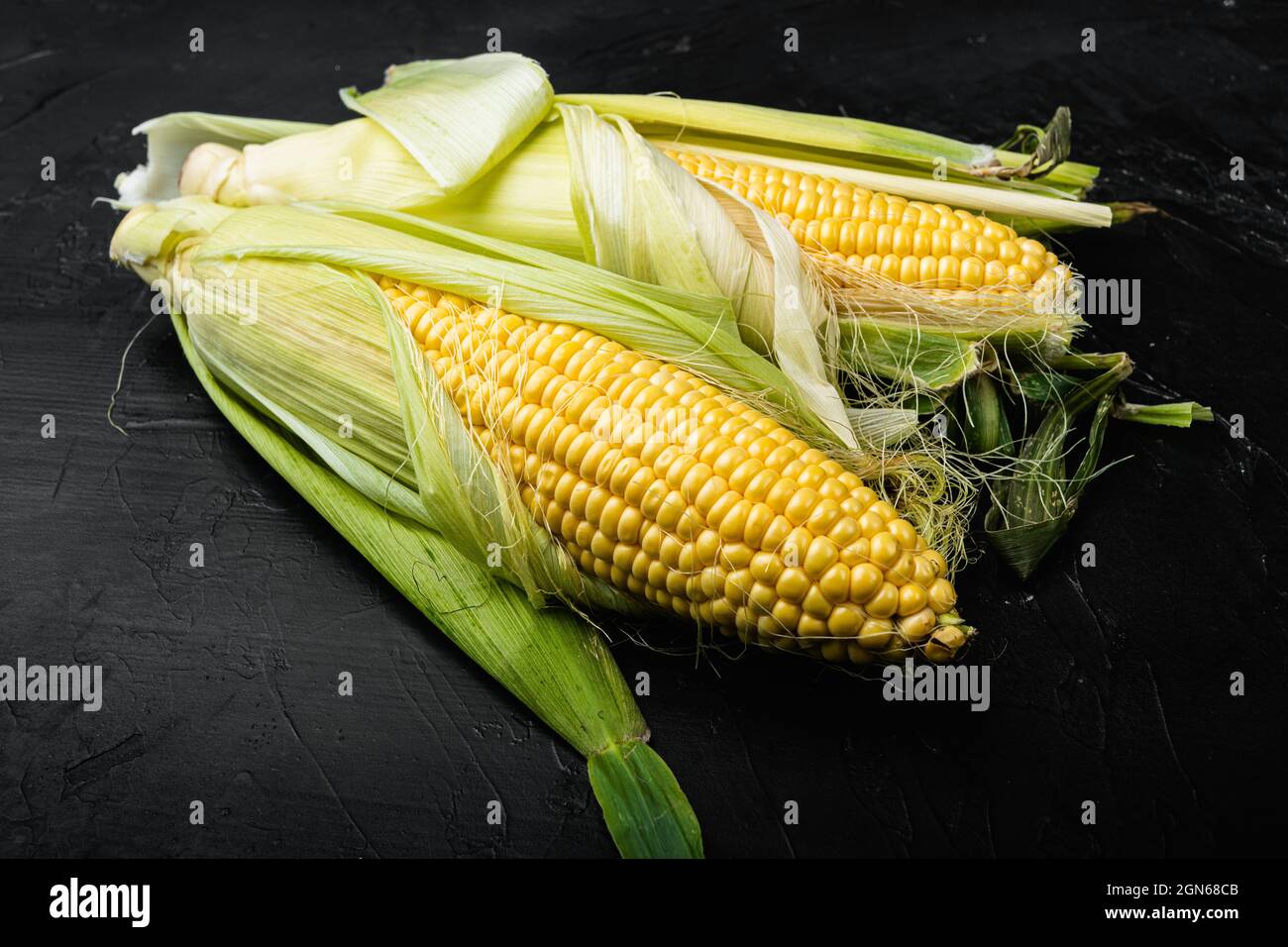 Fresh raw corns set, on black background Stock Photo