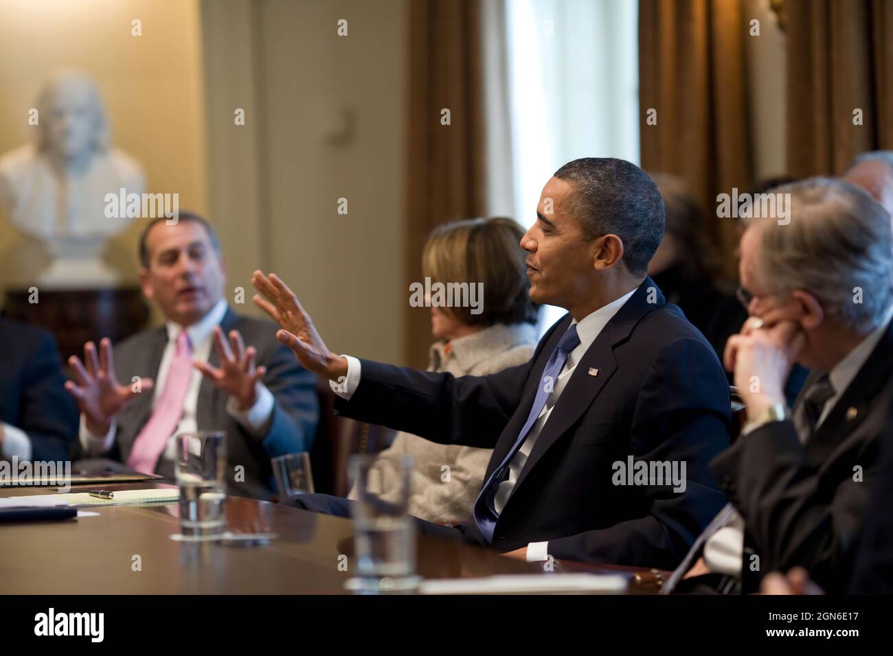 President Barack Obama and House Republican Leader John A. Boehner (R-Ohio) gesture while Speaker of the House Nancy Pelosi (D-Cal.) and Senate Majority Leader Harry Reid (D-Nev.) look on during a meeting of bipartisan leaders of the House and Senate to discuss working together on issues surrounding the economy and jobs in the Cabinet Room of the White House, Feb. 10, 2010.  (Official White House Photo by Pete Souza) This official White House photograph is being made available only for publication by news organizations and/or for personal use printing by the subject(s) of the photograph. The p Stock Photo