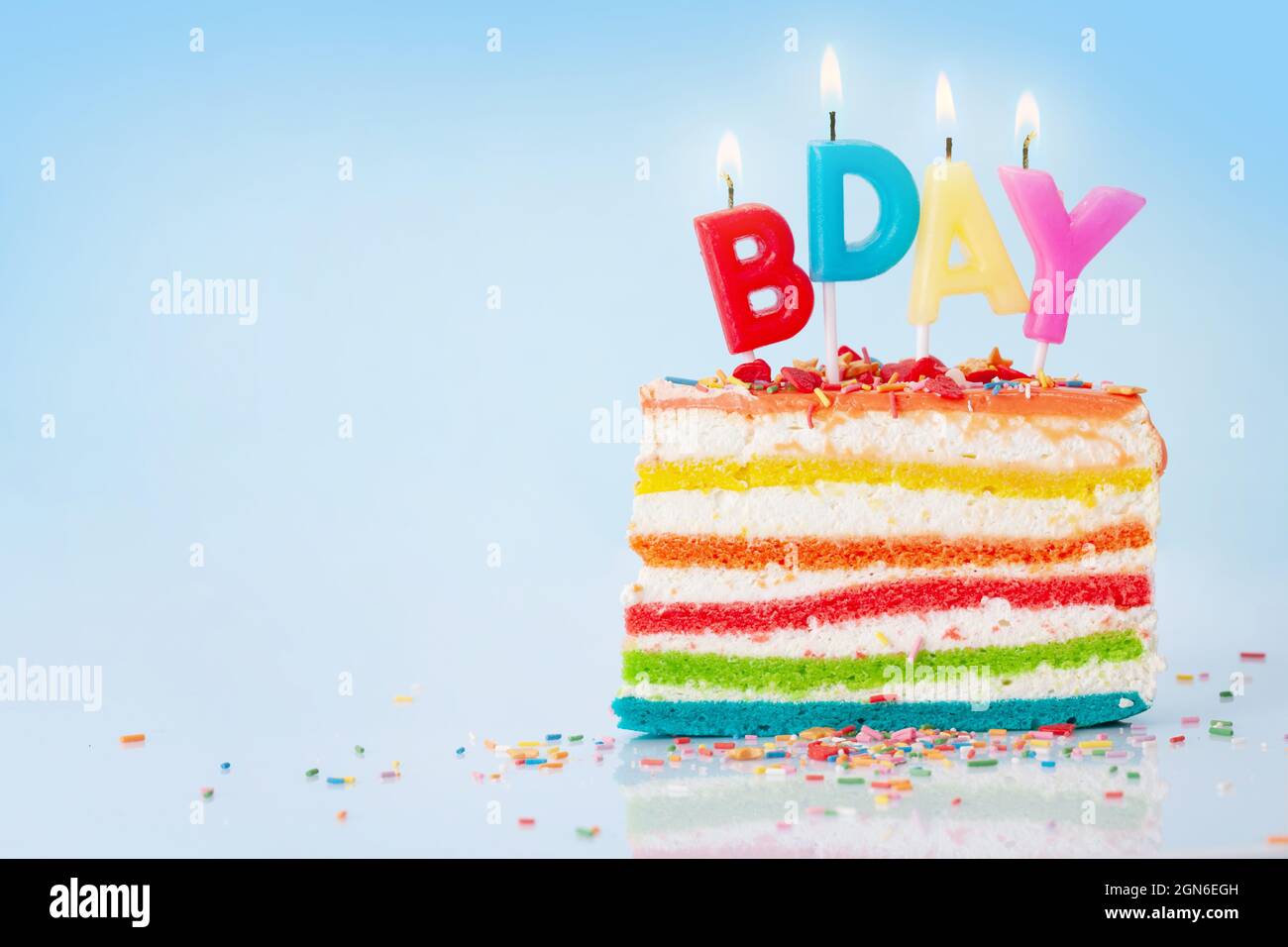 Birthday cake with happy birthday candles on blue background with copy ...