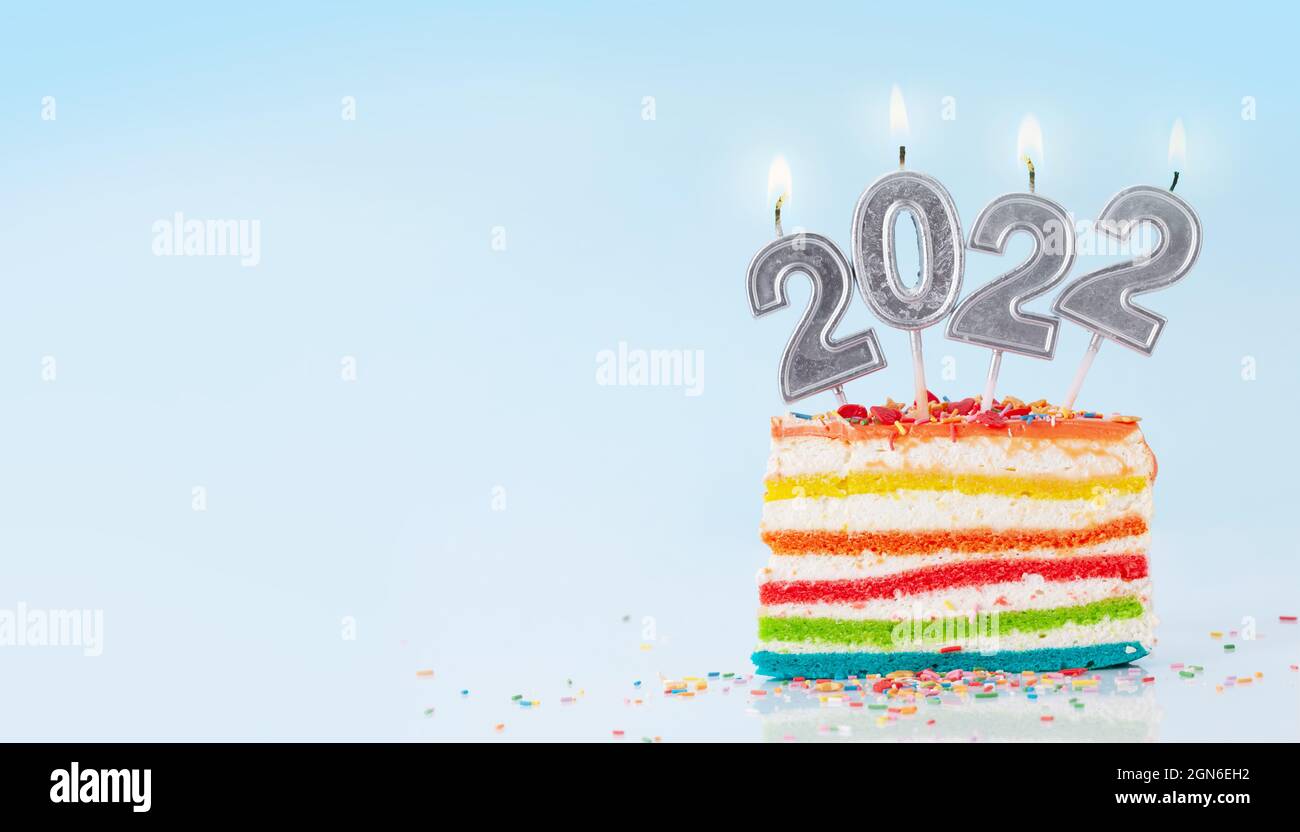 Christmas Cake With Number 2022 Burning Candles On A Blue Background With Copy Space For Your Xmas Greetings Stock Photo - Alamy