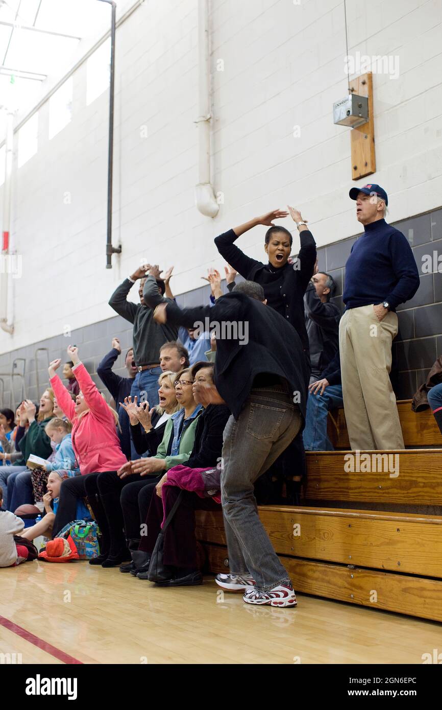 President Barack Obama, First Lady Michelle Obama, Vice President Joe Biden, and Dr. Jill Biden, react while watching Sasha Obama and Maisy Biden play in a basketball game in Chevy Chase, Md., Feb. 27, 2010.  (Official White House Photo by Pete Souza) This official White House photograph is being made available only for publication by news organizations and/or for personal use printing by the subject(s) of the photograph. The photograph may not be manipulated in any way and may not be used in commercial or political materials, advertisements, emails, products, promotions that in any way sugges Stock Photo