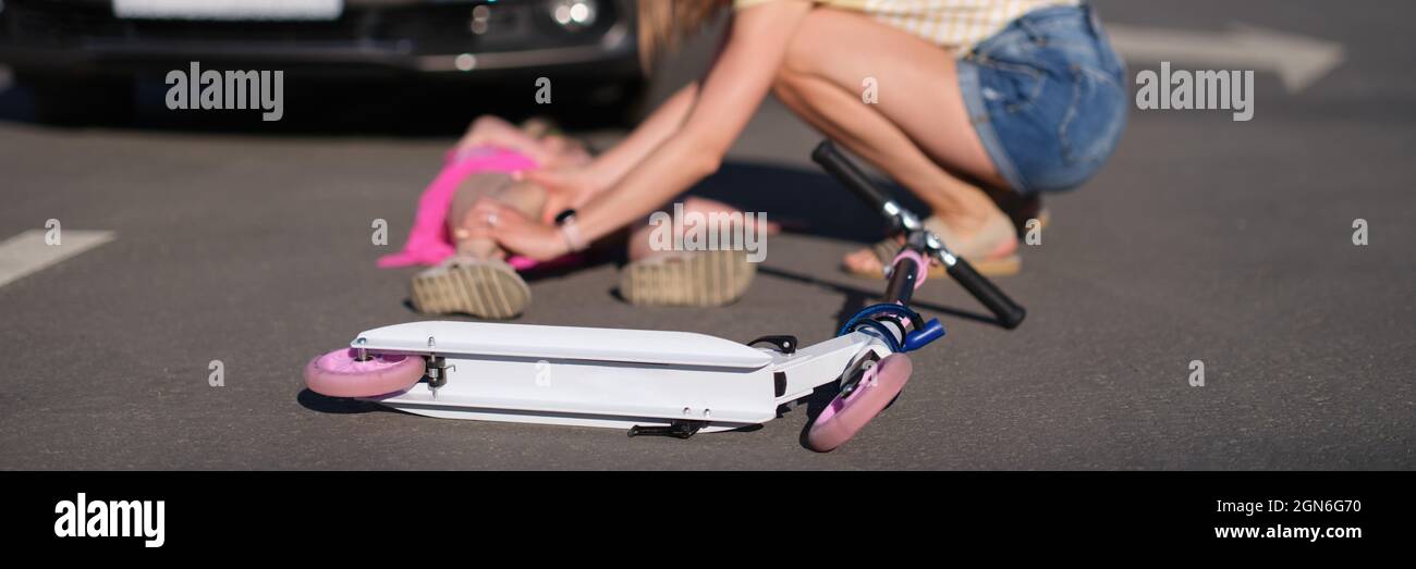 Child scooter lying in front of little girl injured in car accident
