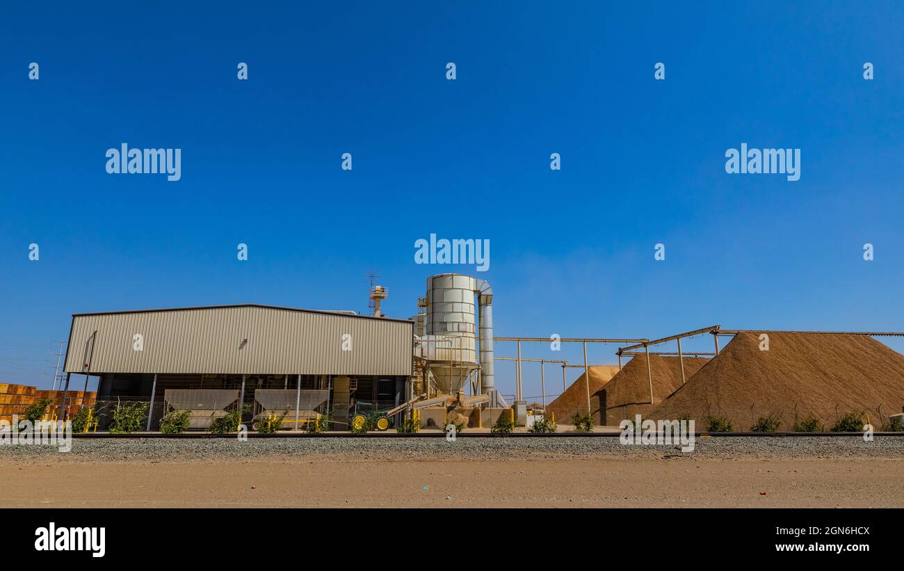 An Almond shelling facility in Westley California with huge piles of