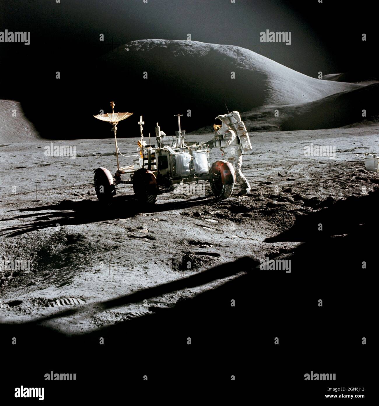 (31 July 1971) --- Astronaut James B. Irwin, lunar module pilot, works at the Lunar Roving Vehicle during the first Apollo 15 lunar surface extravehicular activity (EVA) at the Hadley-Apennine landing site. The shadow of the Lunar Module 'Falcon' is in the foreground. This view is looking northeast, with Mount Hadley in the background. This photograph was taken by astronaut David R. Scott, commander. Stock Photo