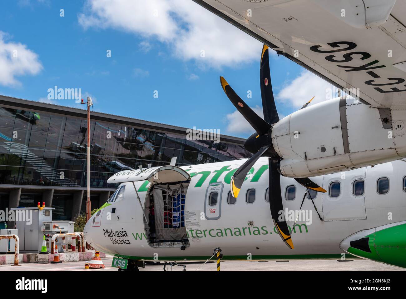 San Cristobal de La Laguna, Spain - August 12, 2021: Propeller airplane provisioning on the runway of Los Rodeos airport. ATR 72 plane of Binter Canar Stock Photo