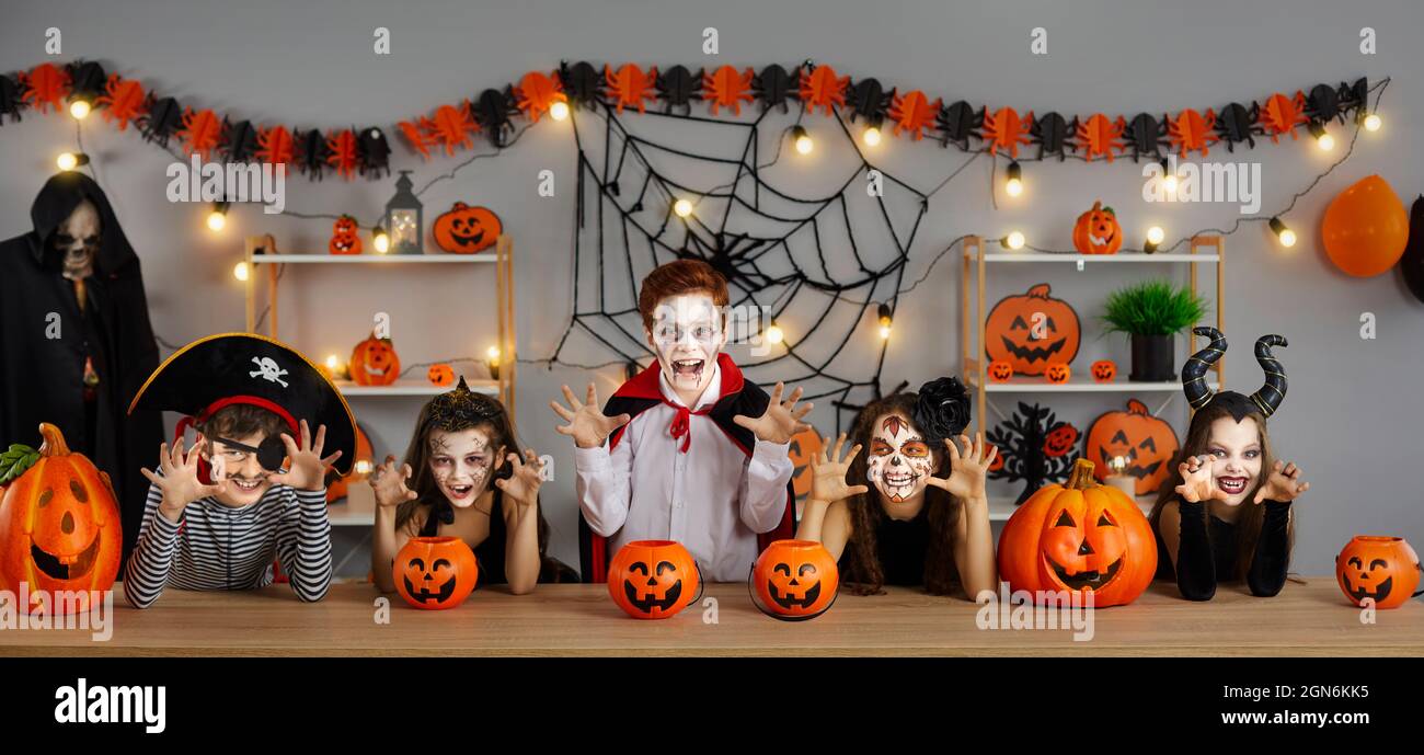 Group of children dressed up as spooky characters are having fun at Halloween party Stock Photo