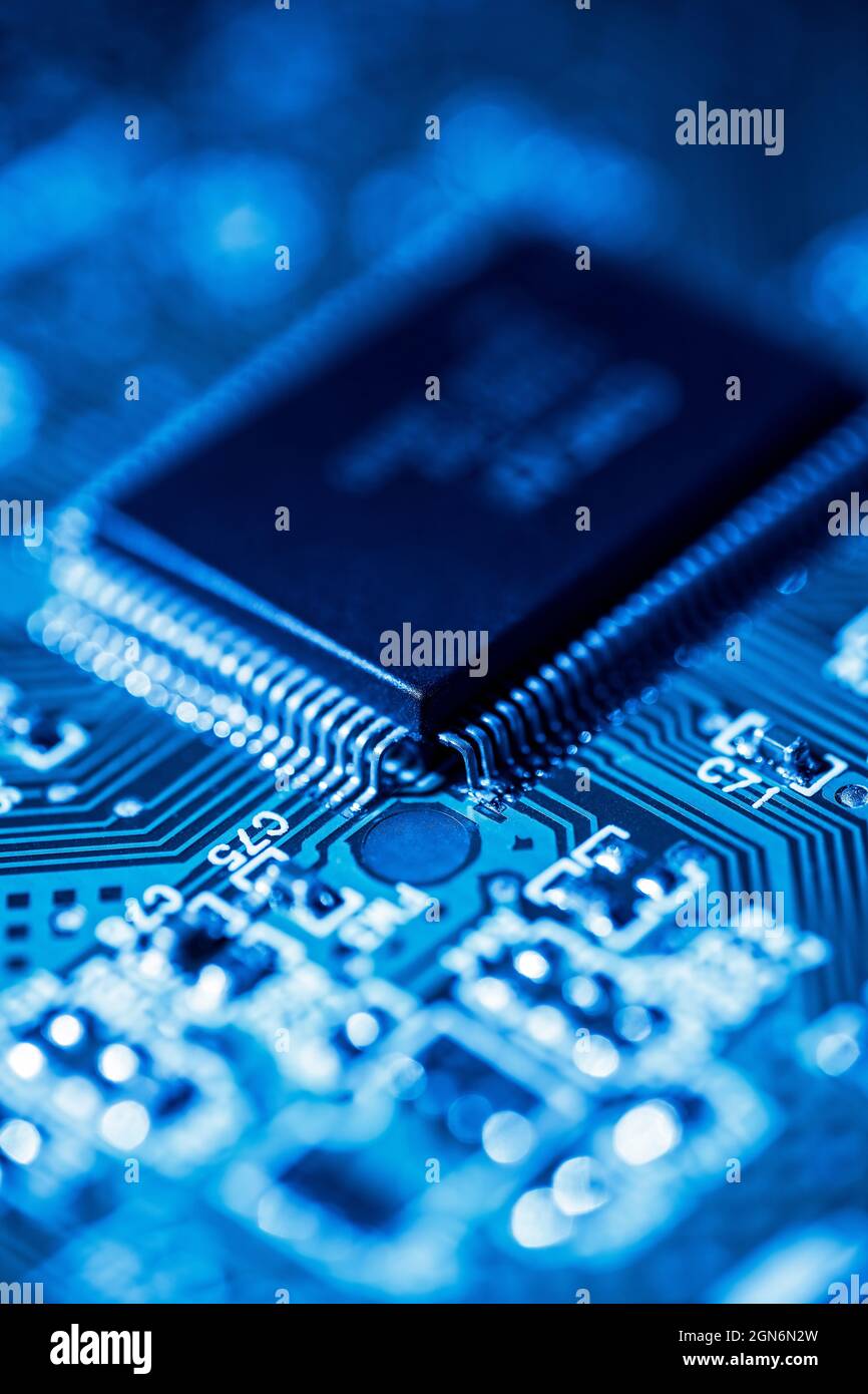 Detail of a computer circuit board in blue light Stock Photo