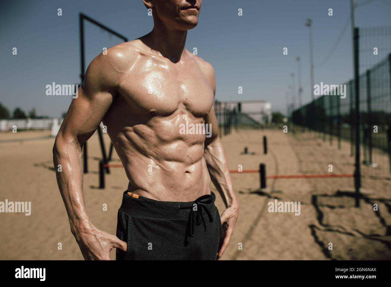 fitness, sport, training and lifestyle concept - young man with beautiful  pumped up body posing on the beach Stock Photo - Alamy