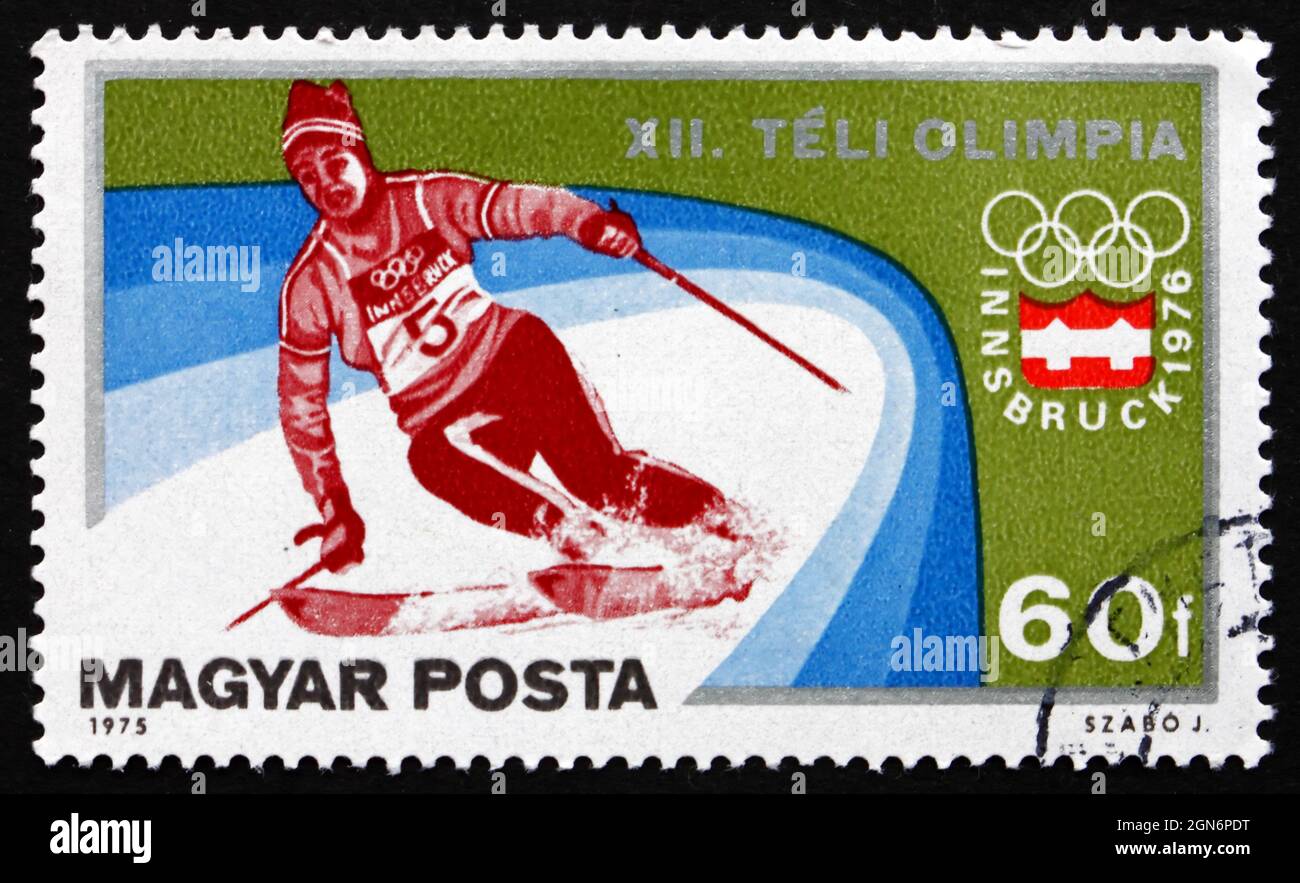 HUNGARY - CIRCA 1975: a stamp printed in the Hungary shows Slalom, Alpine Skiing, Winter Olympic sports, Innsbruck 76, circa 1975 Stock Photo