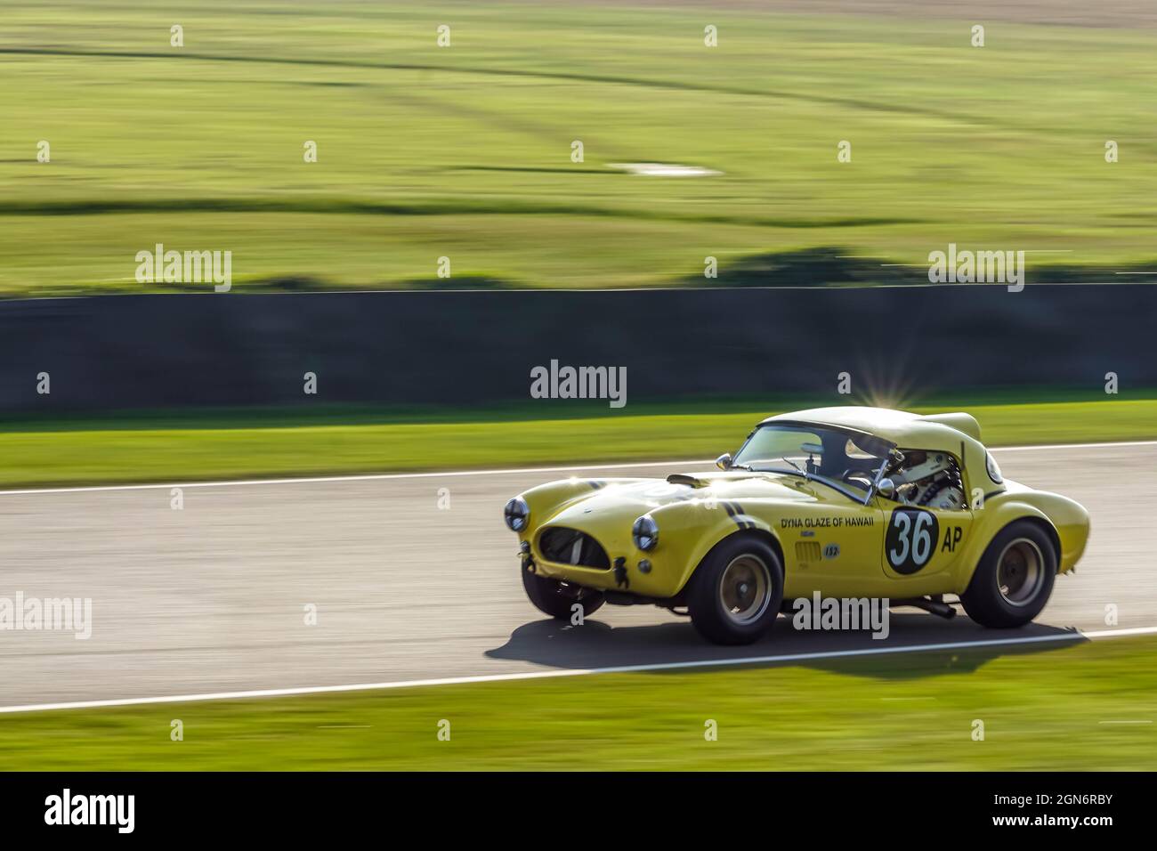 The "Hairy Canary" AC Cobra at speed during practice for the Goodwood