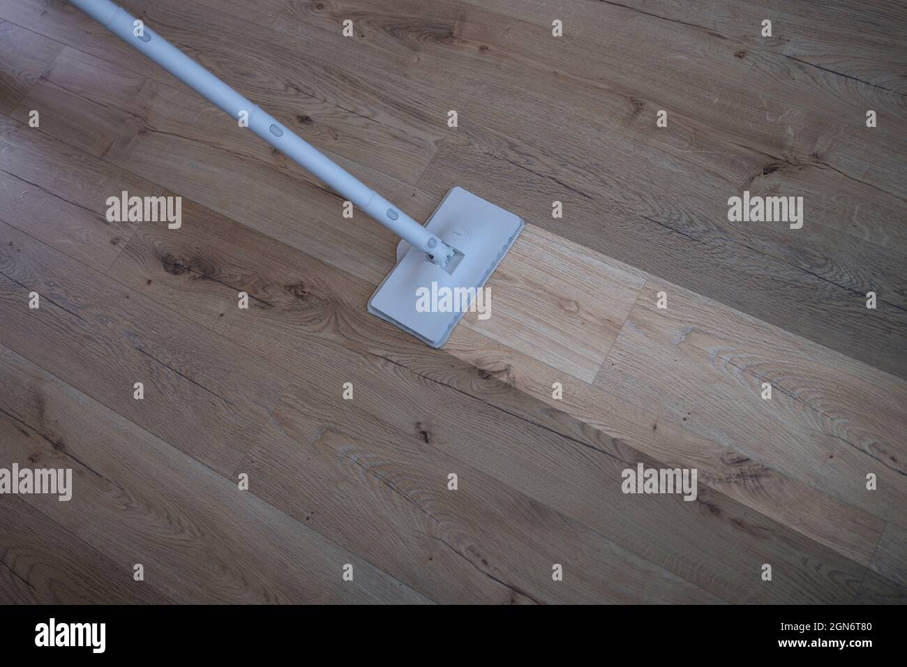 Cleaning wood floor with mop over view Stock Photo Alamy