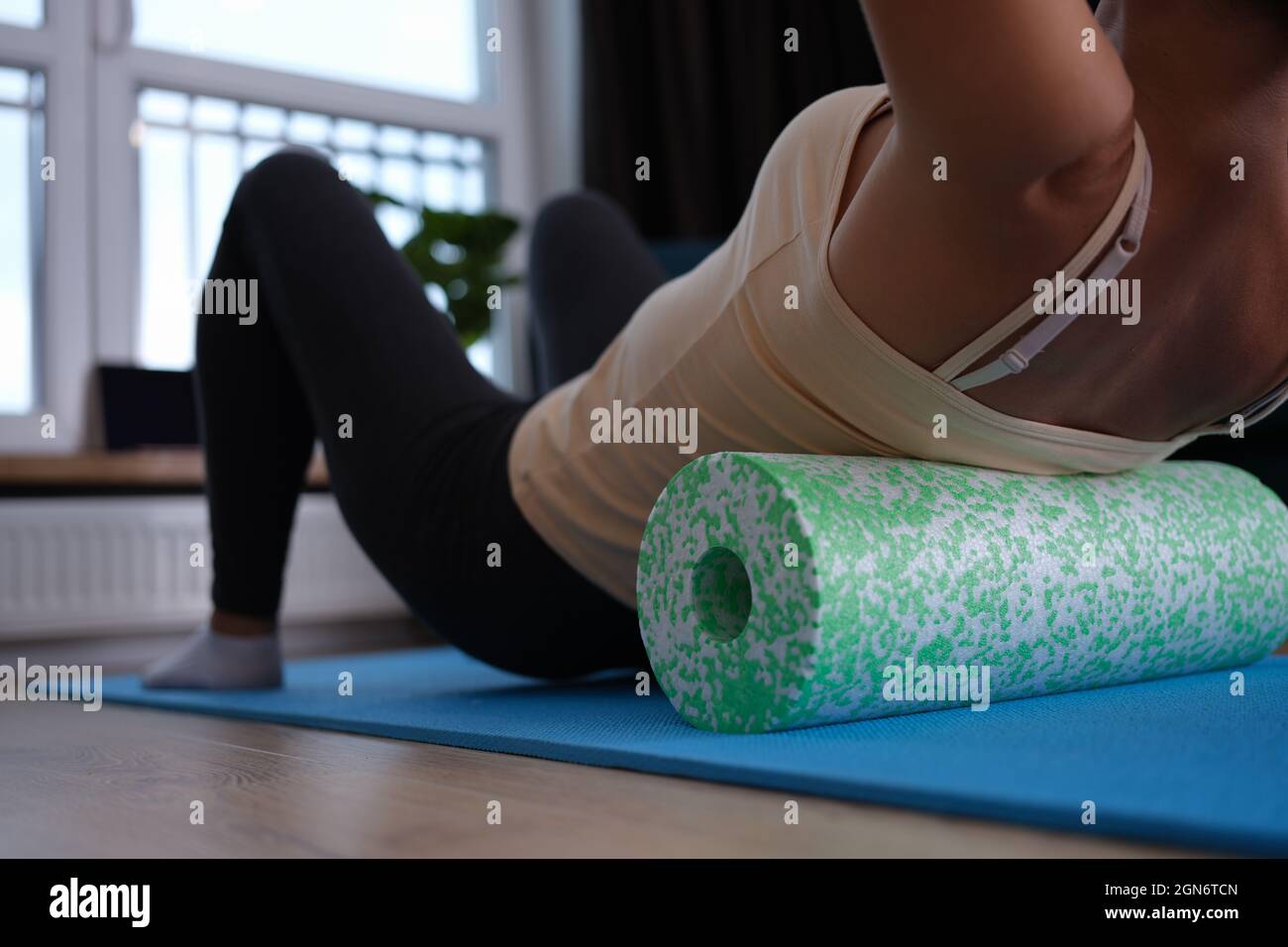 Woman doing foam roller exercises to relieve back pain closeup Stock Photo  - Alamy